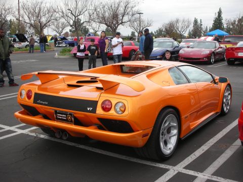 1998 Ford Crown Victoria - Photograph of an orange Lamborghini Diablo VT at an outdoor car meet.