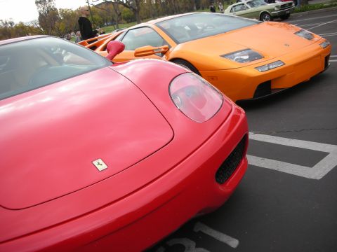 1998 Ford Crown Victoria - Photograph of a red Ferrari front and orange Lamborghini Diablo at an outdoor car gathering.
