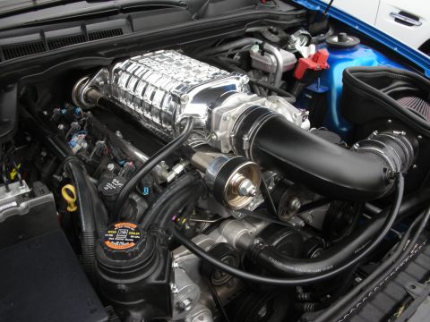 1998 Ford Crown Victoria - The engine bay features a polished supercharger and custom intake system, indicating performance modifications.