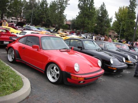 1998 Ford Crown Victoria - A collection of Porsches are gathered at an outdoor event.