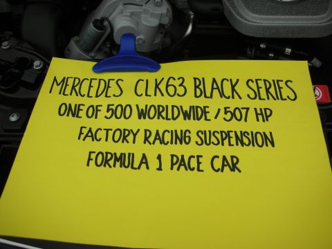 1998 Ford Crown Victoria - Handwritten display card noting Mercedes CLK63 Black Series specs: one of 500 worldwide, 507 hp, F1 pace car.