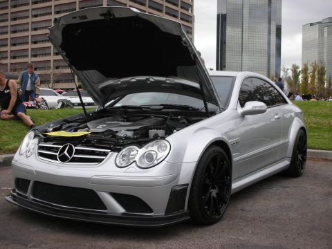 1998 Ford Crown Victoria - A silver Mercedes-Benz CLK coupe is displayed with its hood open, revealing the engine bay and black aftermarket wheels.