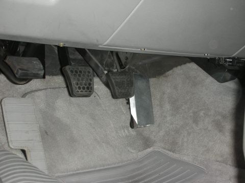 1998 Ford Crown Victoria - The interior footwell shows the brake, accelerator, and clutch pedals, indicating a manual transmission.