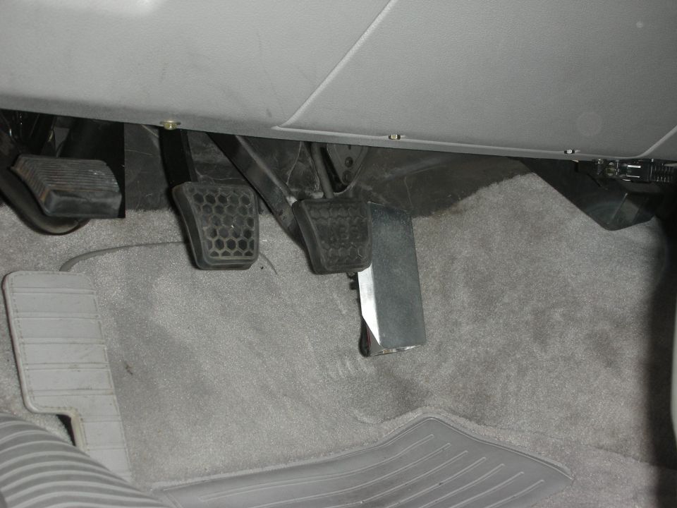 Interior footwell with brake, accelerator, and clutch pedals