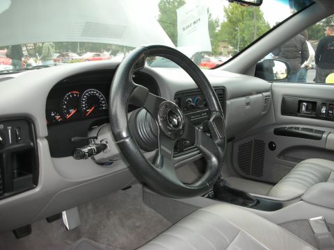 1998 Ford Crown Victoria - Interior of a 1996 Chevrolet Impala SS, showing the dashboard, steering wheel, and seats.