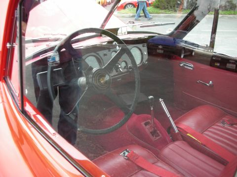 1998 Ford Crown Victoria - Interior view of a red car, showing the dashboard, steering wheel, and seats.