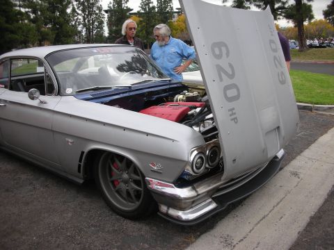 1998 Ford Crown Victoria - Customized classic car with hood open, displaying its engine and "620 HP" marking.