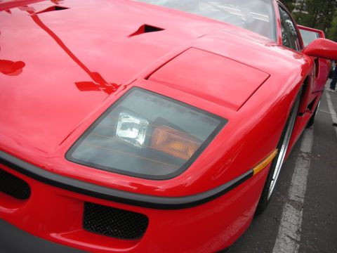 1998 Ford Crown Victoria - The distinctive pop-up headlight and angular design of this red sports car are visible.