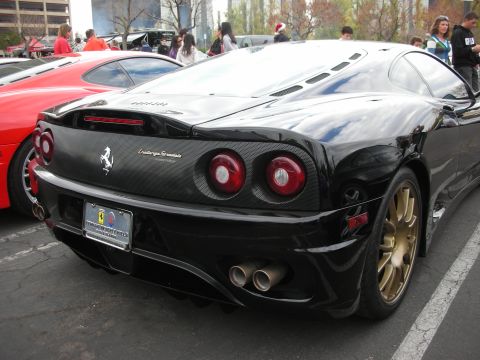 1998 Ford Crown Victoria - The rear of a black Ferrari 360 Challenge Stradale is shown, parked next to a red sports car.