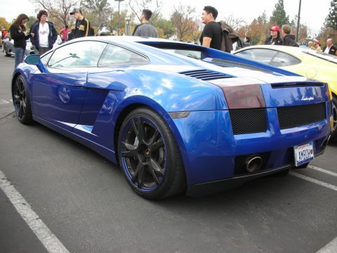 1998 Ford Crown Victoria - Blue Lamborghini Gallardo with custom wheels and a personalized license plate.
