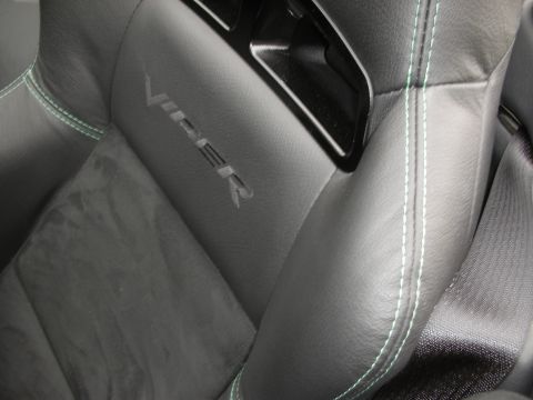 1998 Ford Crown Victoria - Close-up of a black leather car seat green contrast stitching and the embossed 'VIPER' logo.