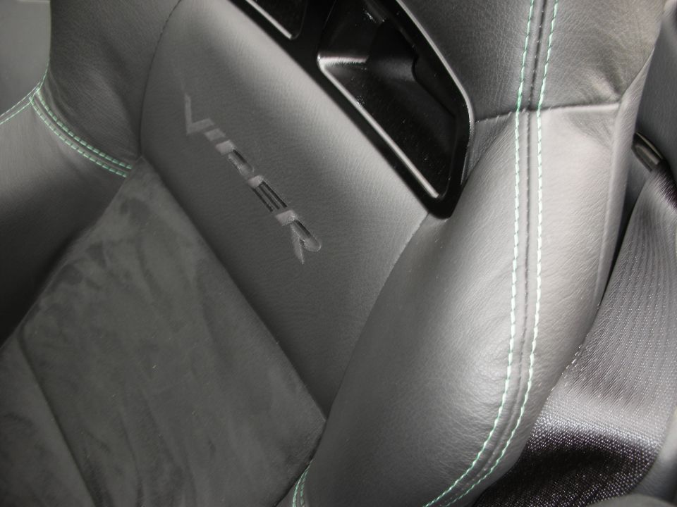 Black leather seat with green stitching and embossed 'VIPER' logo