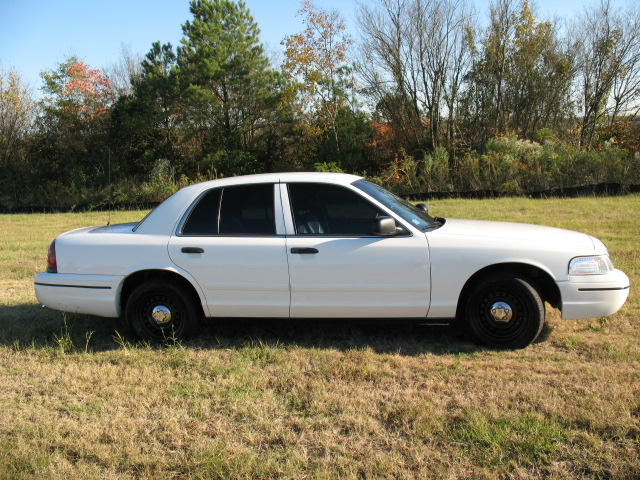 White 2000 Ford Crown Victoria sedan parked outdoors.