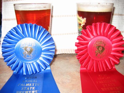 1985 Ford LTD Crown Victoria - Two award ribbons are displayed in front of two glasses of beer, suggesting a competition or event.