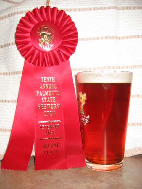 1985 Ford LTD Crown Victoria - A red ribbon awarded for second place sits next to a glass of beer.
