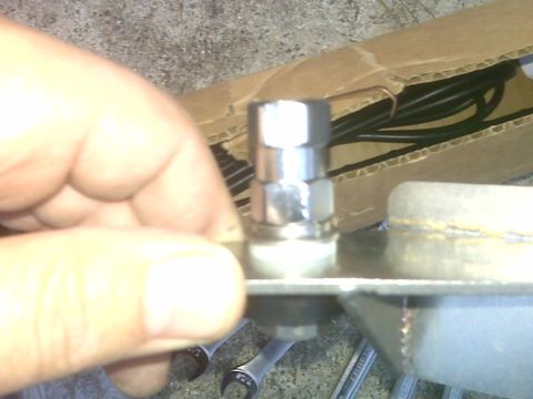 2008 Jeep Wrangler - A hand is holding a shiny metal fitting that appears to be part of a vehicle's exhaust system. In the background, a cardboard box contains…