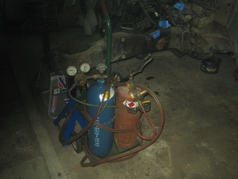 1990 Ford Bronco - Photograph of an oxy-acetylene torch cart with gas bottles and gauges in a shop, not a document.