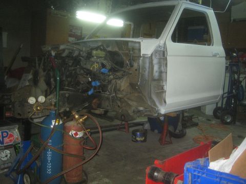 1990 Ford Bronco - Photograph of a truck cab and chassis under restoration in a garage, not a technical document.