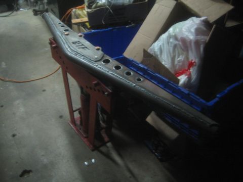 1990 Ford Bronco - Photograph of a fabricated FTF steel frame member on a stand in a shop, not a technical document.