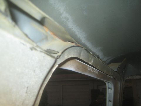 1990 Ford Bronco - Photograph of sheet-metal body repair at a vehicle roof and pillar corner, not a technical document.