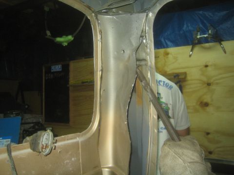 1990 Ford Bronco - Photograph of a welded body pillar and door opening on a vehicle under restoration, not a document.