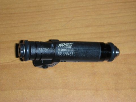 1998 Ford Crown Victoria - Photograph of a black Edge Racing fuel injector with part numbers, resting on a wooden table.