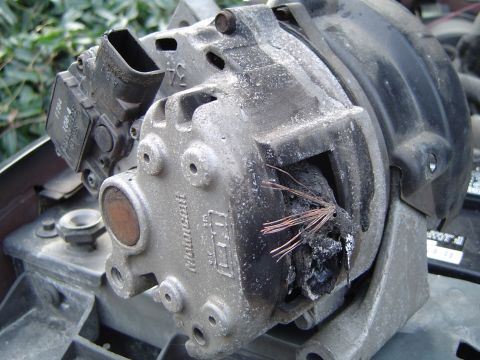 1991 Ford Bronco - Alternator shows significant damage from overheating, with exposed and melted wiring.