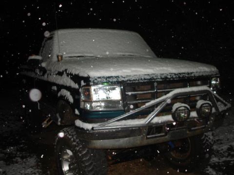 1996 Ford F-150 - A Ford F-Series truck is seen in the snow at night. The grille guard is equipped with auxiliary lights.