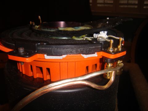 1996 Ford Bronco - Close-up view of a speaker component, showing its orange housing and electrical connections.