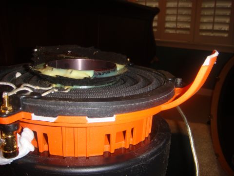 1996 Ford Bronco - This car speaker shows significant damage to its surround and cone, indicating it is no longer functional.