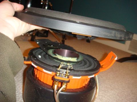 1996 Ford Bronco - A disassembled speaker is shown, revealing its internal components and wiring.