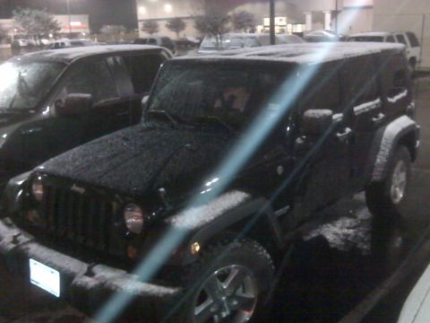 2008 Jeep Wrangler - A black 2008 Jeep Wrangler is parked in a lot covered in snow.