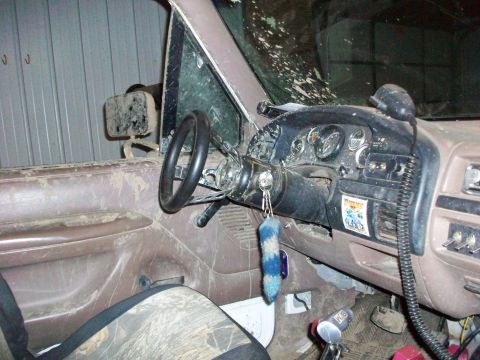 1992 Ford F-350 - The interior of this truck is covered in dirt and grime, with a fuzzy keychain hanging from the ignition.