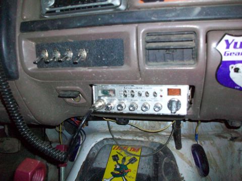 1992 Ford F-350 - The dashboard of a truck displays a CB radio, auxiliary switches, and air vents, with a sticker on the right side.