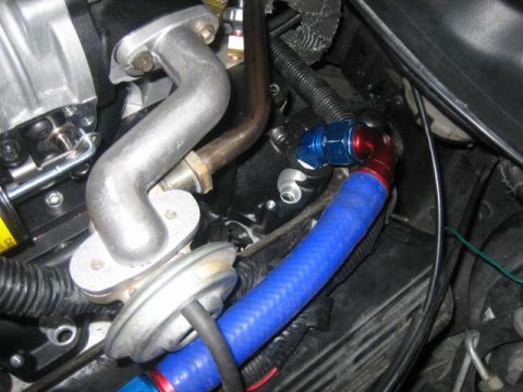 1996 Ford Thunderbird - Close-up view of engine components including hoses and metal tubing.