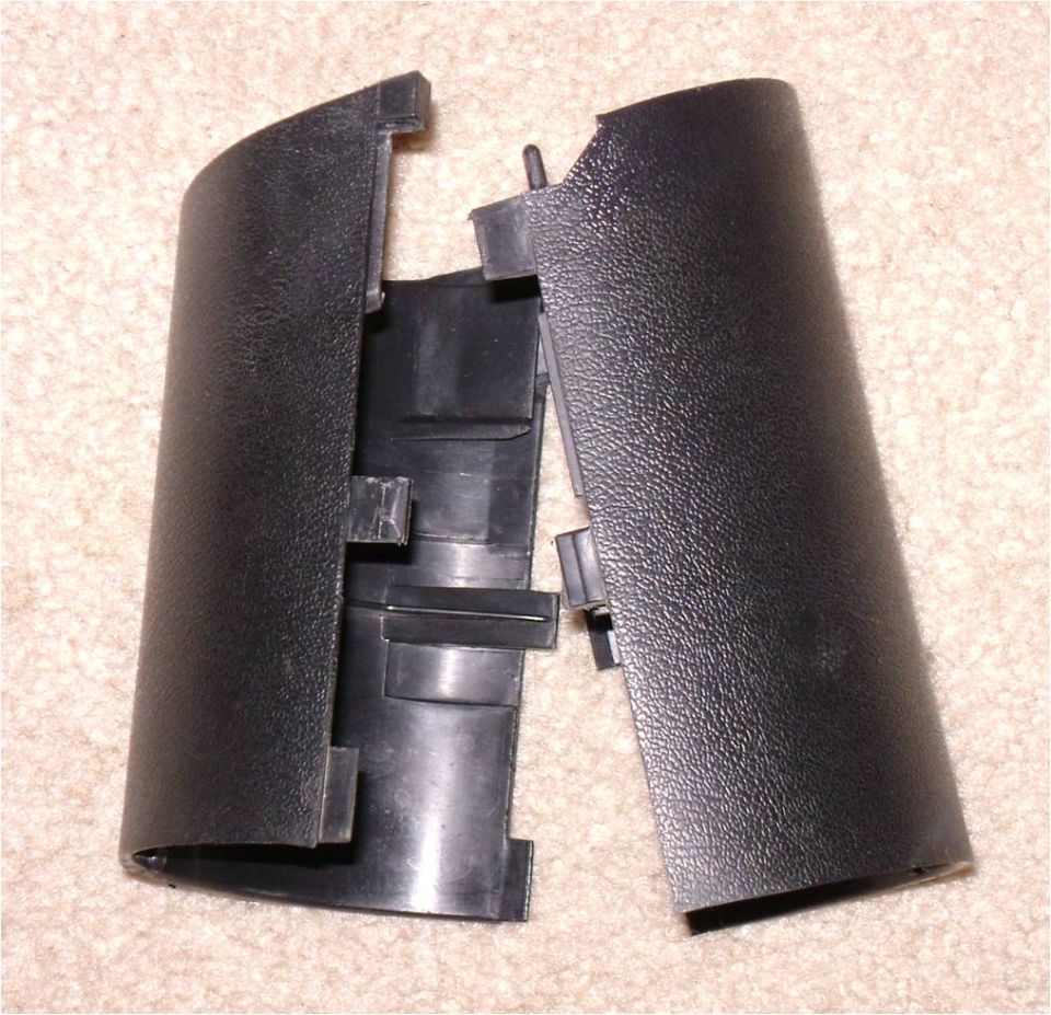 Black plastic trim panel pieces on carpet