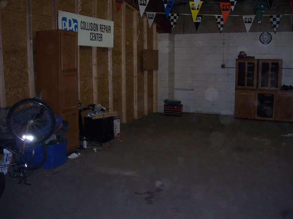 Collision Repair Center sign above cabinets and a bicycle wheel
