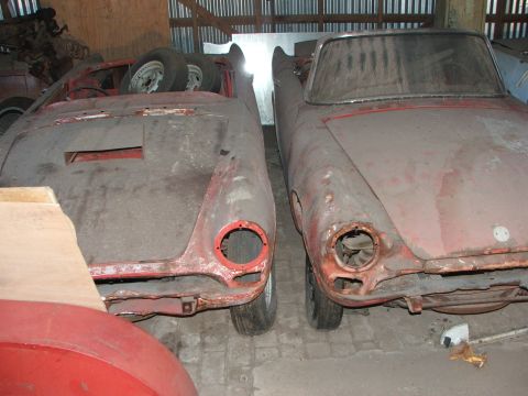 1965 Ford Mustang - Two vintage sports car bodies sit in storage, awaiting restoration.