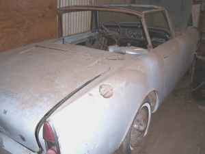 1965 Ford Mustang - This 1965 Ford Mustang convertible is covered in dust, showing its 3q-front view.