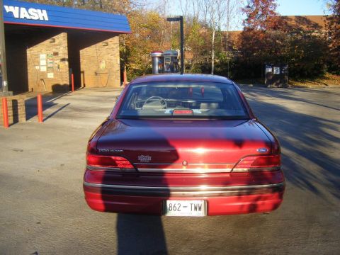 1994 Ford Crown Victoria - Rear view of a red 1994 Ford Crown Victoria at a car wash.