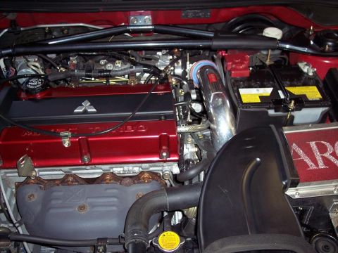 1991 Mitsubishi Eclipse - Close-up of a Mitsubishi engine bay, a red valve cover with the brand's logo and "TURBO" text.