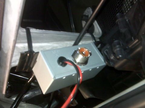 2008 Jeep Wrangler - A close-up view shows a small gray electronic box with a silver connector and red and black wires attached. The box appears to be mounted w…