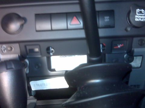 2008 Jeep Wrangler - This is an interior shot of a vehicle's dashboard, focusing on the center console area. Visible elements include a power outlet, hazard lig…
