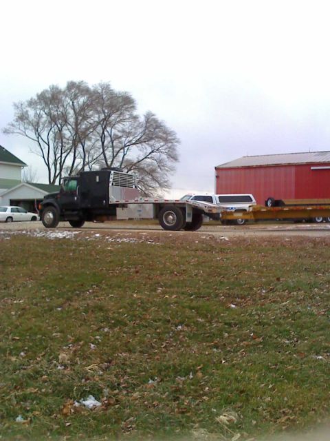 1992 Ford Bronco - Photograph of a flatbed truck and trailer, not a technical document.