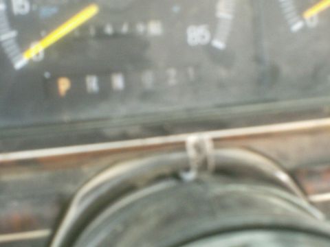 1991 Ford Bronco - A close-up of a vehicle's dashboard shows the gear indicator with 'P R N D 2 1' illuminated, and a speedometer with a needle pointing past…