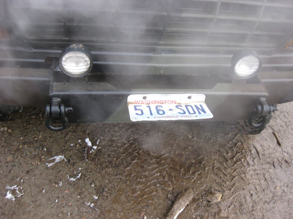 Front bumper of a vehicle with headlights and Washington license plate 516-SDN.