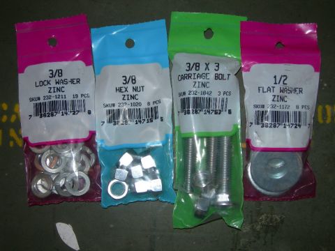 1991 Jeep Wrangler - Four plastic packages of assorted zinc-plated hardware are laid out on a dark, possibly concrete, surface. The packages contain lock washer…
