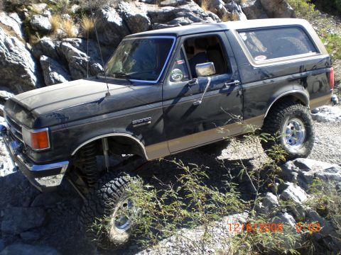 1991 Ford Bronco - This 1991 Ford Bronco navigates a challenging rocky trail, its off-road capabilities.