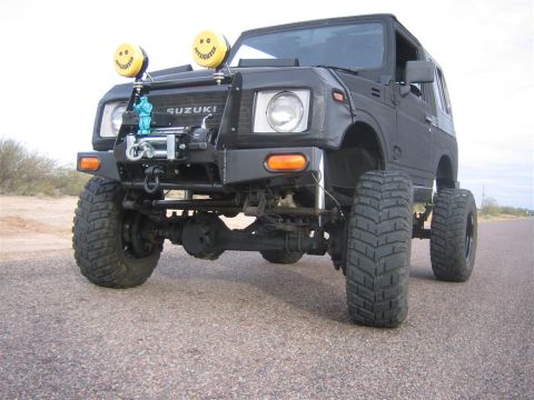 1987 Suzuki Samurai - This modified 1987 Suzuki Samurai features a lifted suspension, aggressive tires, and custom lighting, including two yellow smiley face spo…