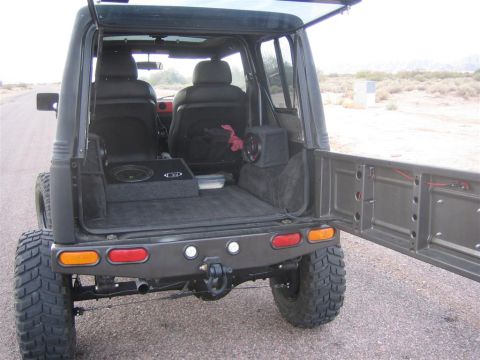1987 Suzuki Samurai - This Suzuki Samurai has been modified with large tires and a custom sound system in the cargo area.